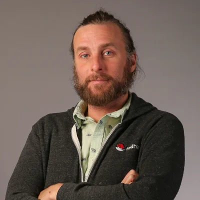 Tim Hildred stands with arms crossed.