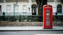 Red telephone booth on a street in England