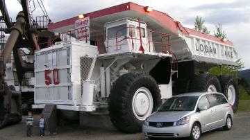 Dump truck with kids standing in the foreground